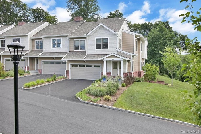 View of front of home featuring a front yard and a garage