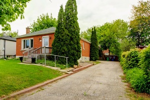 Beautiful 2 2 bedroom, 2 bath, all brick detached bungalow with a separate side entrance on a premium 50' X 130' lot !