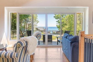 Top 5 Reasons You Will Love This Home 1 Almost waterfront, bask in unique full water views of Georgian Bay from the main living areas and deck, providing a serene ...
