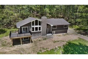 Set in the desirable Pine Bush School District, this 3, 300 sq ft custom Raised Ranch Chalet style home on aprox 3 acres blends rustic charm with modern sophistication.
