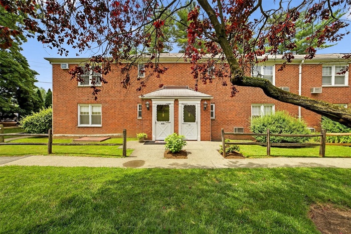 View of front of house with brick siding and cooling unit