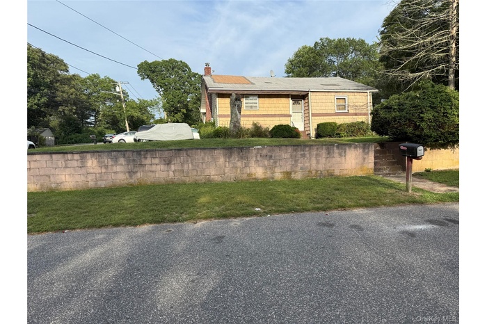 View of front of house featuring a chimney