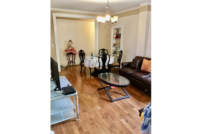 Living room with wood finished floors and a chandelier