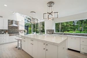 A stunning example of a custom designed home to enhance daily life with an open concept floor plan of primary living spaces and truly magazine worthy.