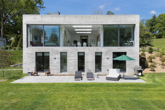 Back of house with a patio area and a yard