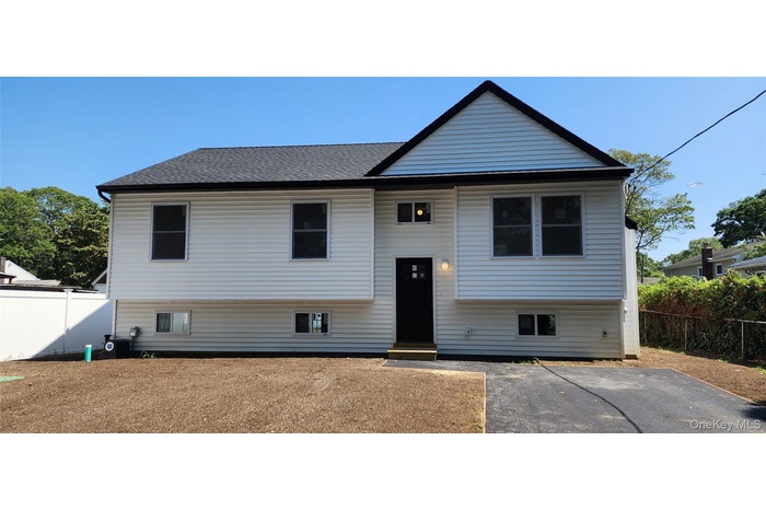 View of front of home featuring roof with shingles