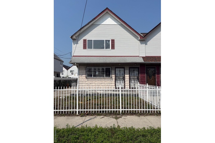 View of front of house featuring a fenced front yard and covered porch