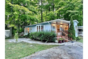 Located in the highly sought after Park Place 55 gated community, this charming FOUR SEASON 2 bedroom, 2 bathroom home is nestled among mature maple trees beneath a stunning forest ...