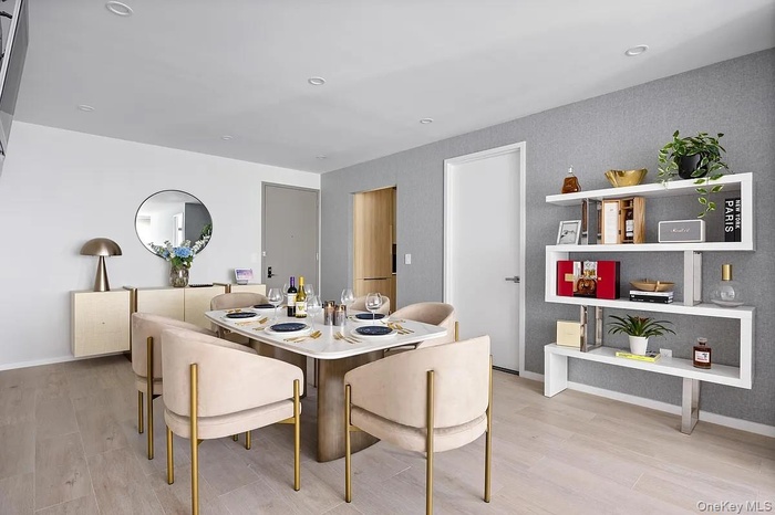 Dining area with light wood-style floors and recessed lighting