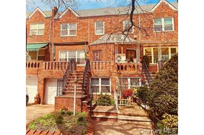 View of front facade with stairs, concrete driveway, and a garage