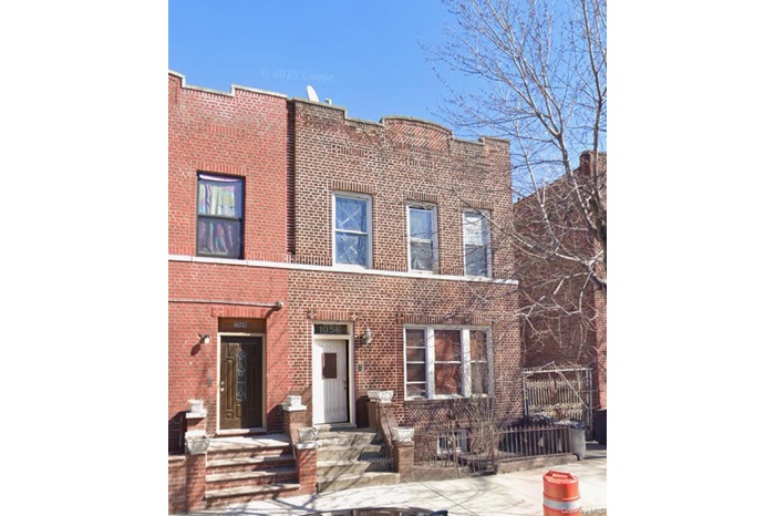 View of front facade featuring brick siding