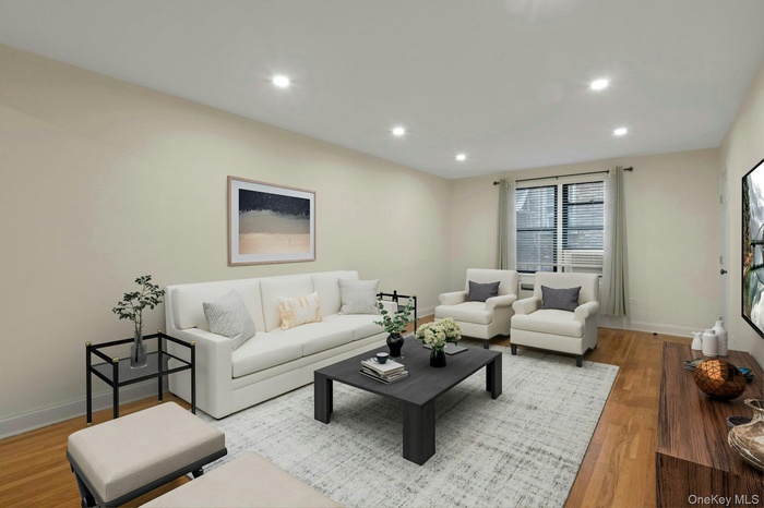 Living area with wood finished floors and recessed lighting