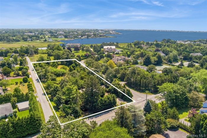 Aerial view of property's location featuring a large body of water and property boundaries highlighted