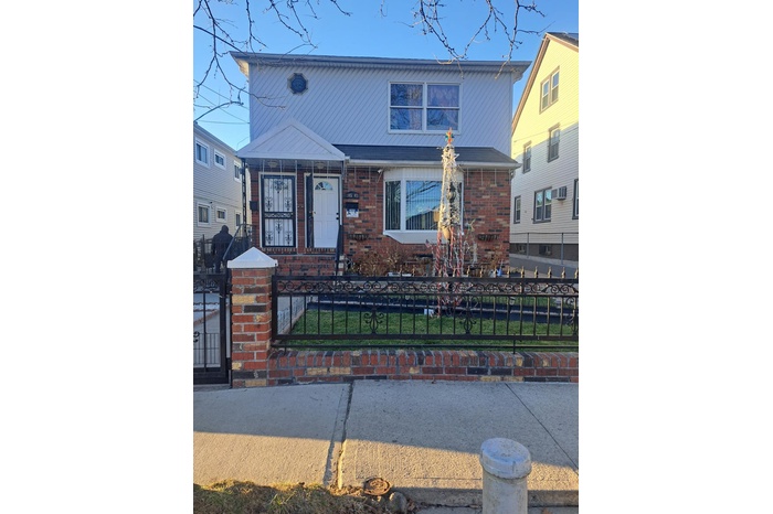 View of front of property featuring a fenced front yard and brick siding