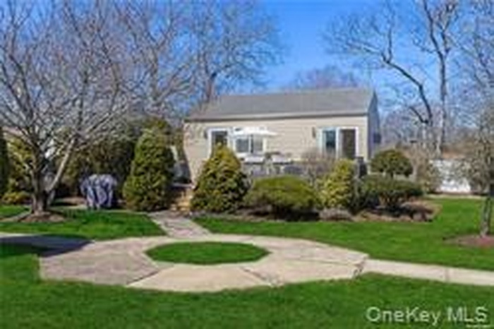 Rear view of property with a yard
