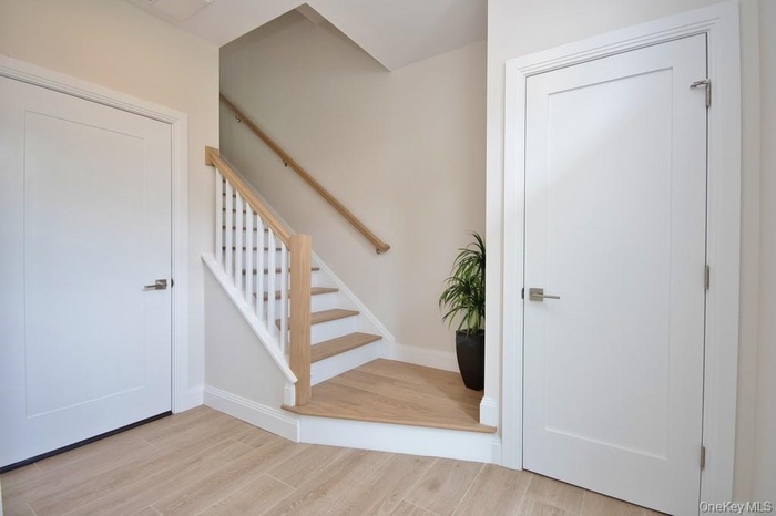 Entryway featuring light wood-style floors and stairway