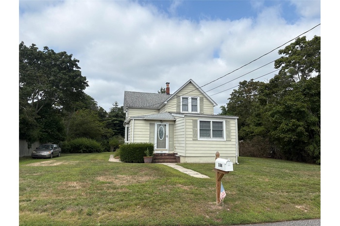 Bungalow-style house featuring a front yard, a chimney, and roof with shingles