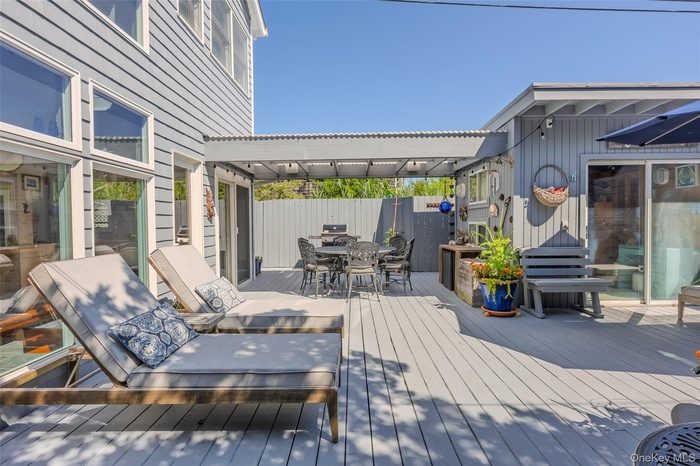 Wooden deck featuring outdoor dining space