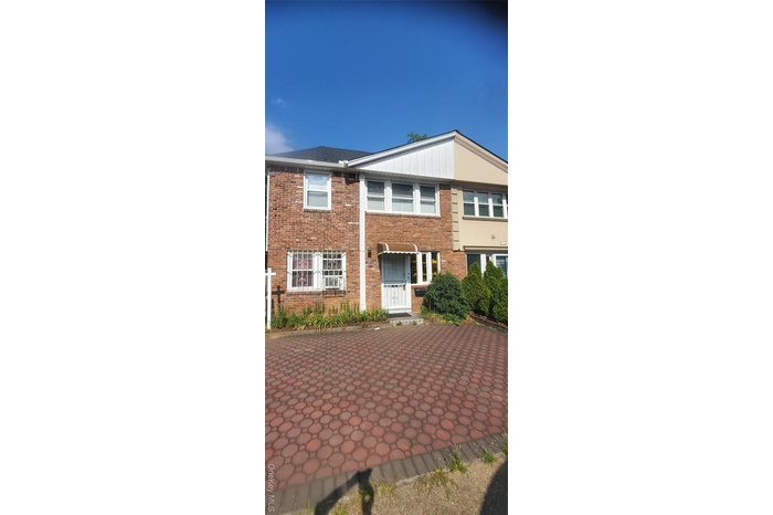 View of front of house with brick siding
