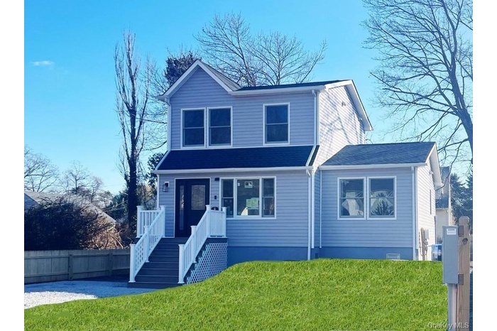 View of front of property with roof with shingles