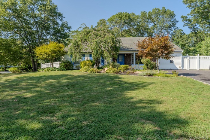 View of property hidden behind natural elements featuring a porch