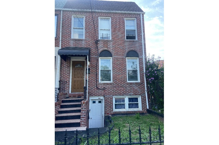 View of front facade with brick siding and a front yard