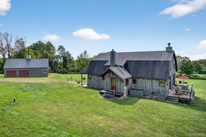 Step into serene sophistication with this immaculate custom contemporary Gambrel style country home, a true architectural showpiece blending rustic charm with modern design.