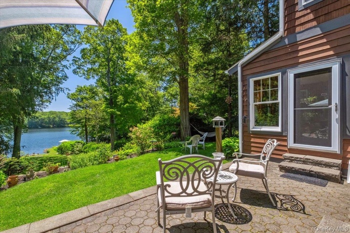 View of patio with a water view