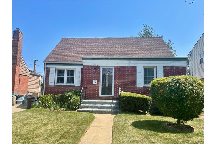 Bungalow featuring brick siding, roof with shingles, and a front lawn
