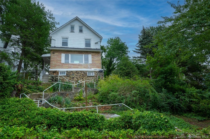 View of property exterior featuring stone siding