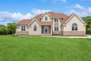 Nestled in the heart of Southold s coveted North Fork, 1465 Ackerly Pond Lane offers a rare opportunity to own a custom home on over 2.