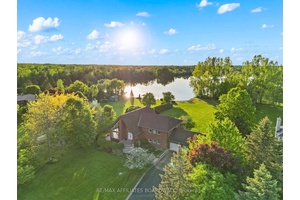 Tucked away in the exclusive community of Lakeland Estates, this custom waterfront retreat offers 1.