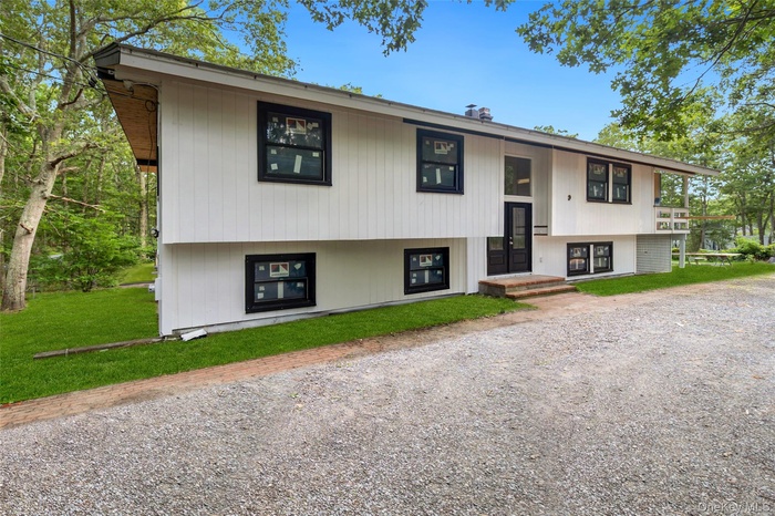 Split foyer home featuring a front lawn