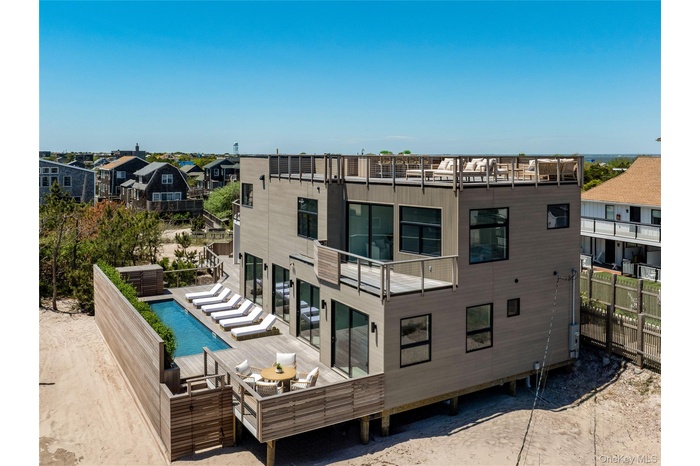 Rear view of property with a wooden deck, a residential view, and an outdoor pool