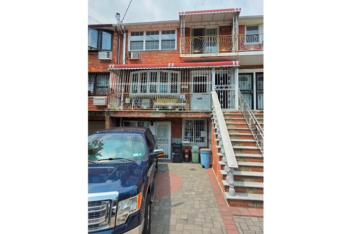 Back of house with brick siding and stairs