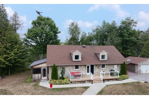 A TRULY REMARKABLE PROPERY This stunning brick and stone bungalow sits on a 50 acre lot, offering the perfect blend of elegance and tranquility.