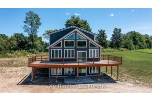 Nestled atop a hill, this elegant new home is set on just under 5 acres.