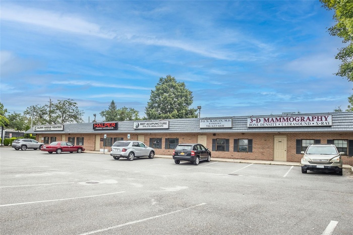 View of property with uncovered parking
