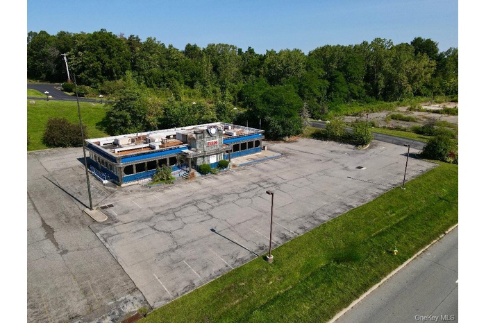 View of subject property with view of the paved parking area