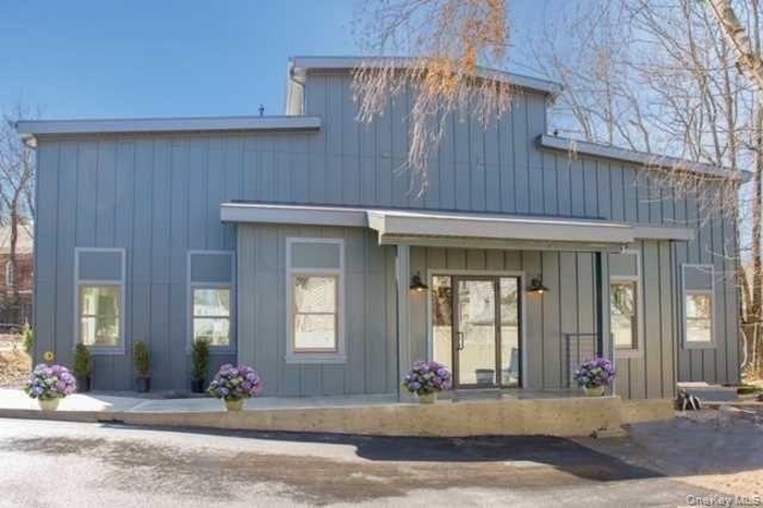 Rear view of property with board and batten siding