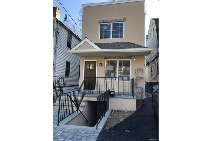 High-end new construction in North Riverdale. Stucco exterior, plus architectural details.
