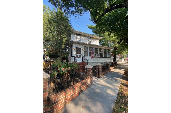 View of front of home featuring a fenced front yard and a sunroom