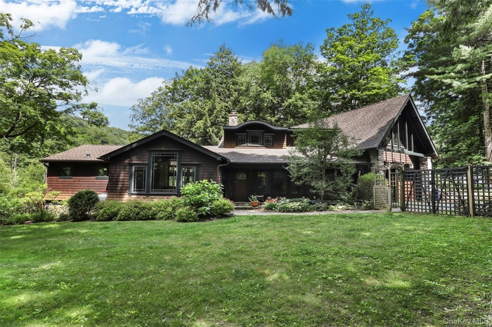 View of front of Arts & Crafts style lakefront home