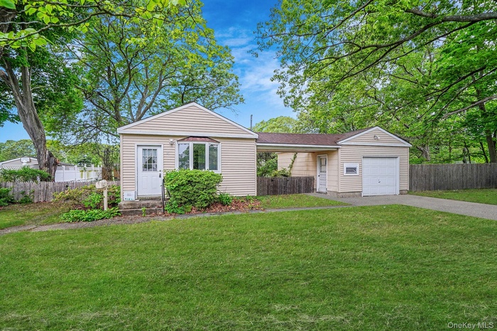 View of front of property featuring driveway and an attached garage