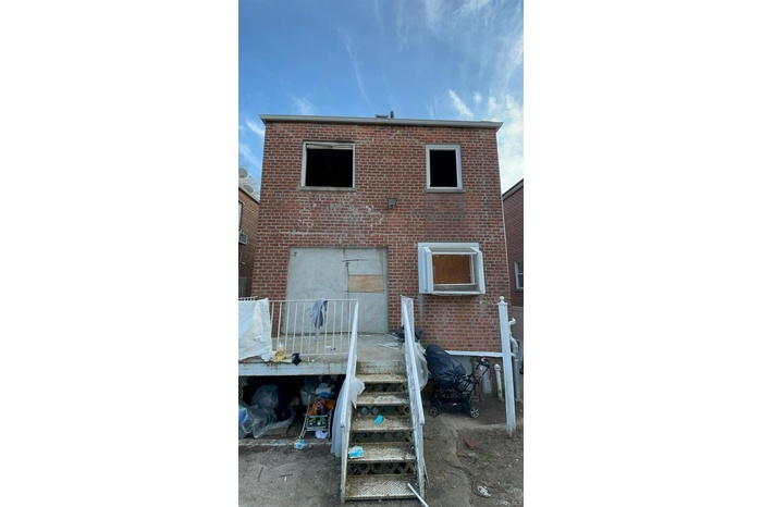 Back of property featuring brick siding