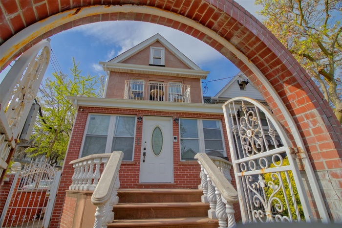 View of front facade featuring brick siding