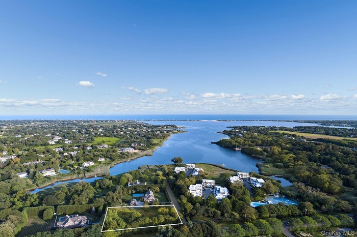 Aerial view of property's location with property parcel outlined and a nearby body of water