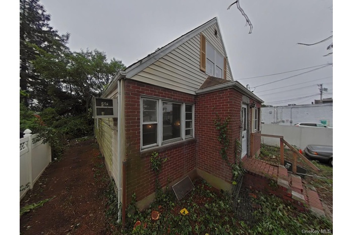 View of property exterior featuring brick siding
