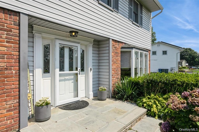 Entrance to property featuring brick siding