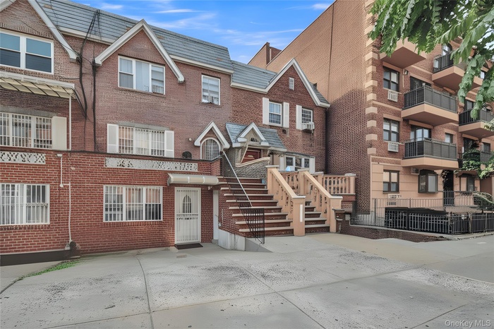 View of front of house featuring brick siding and stairway